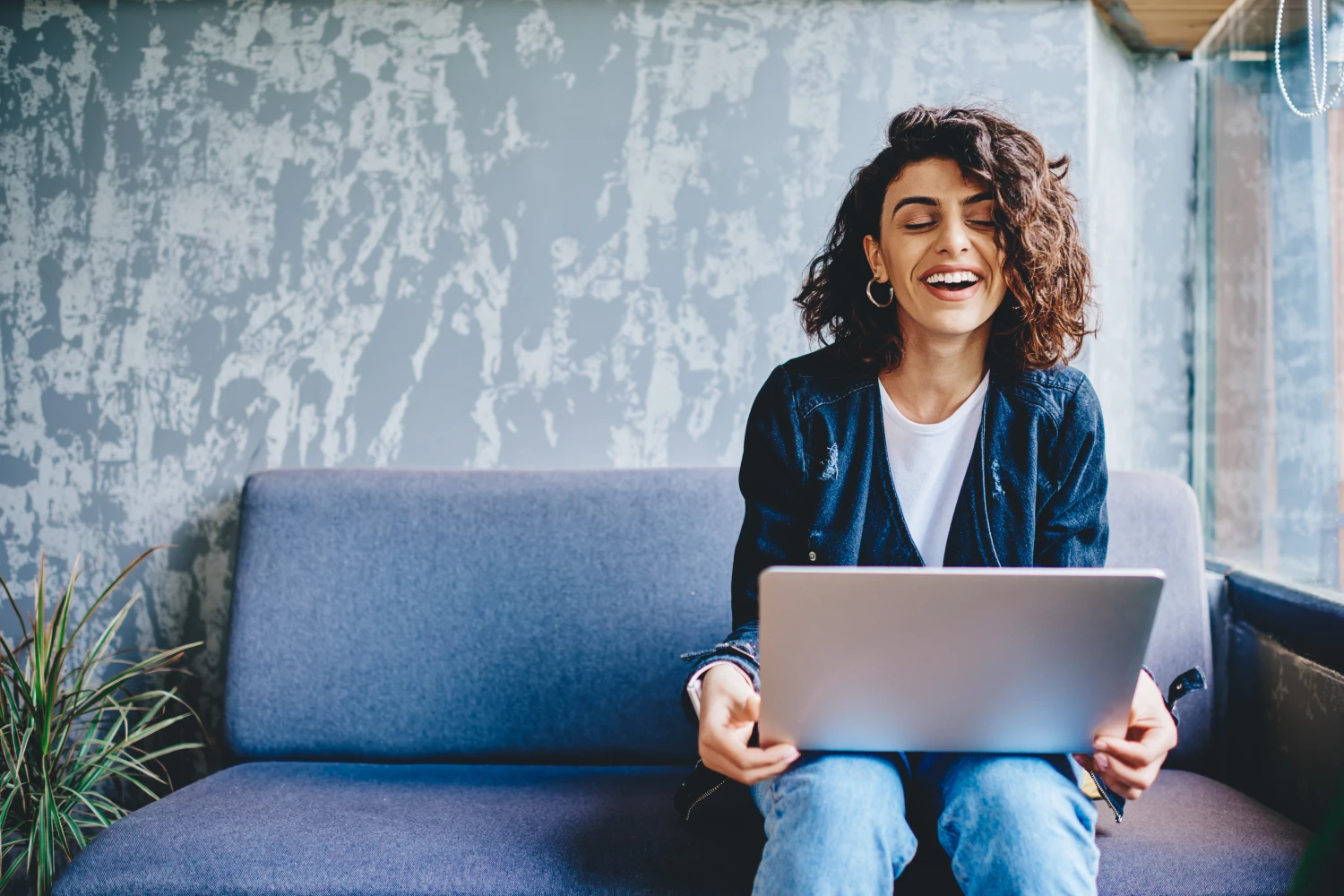 A pretty woman smiling browsing on a laptop